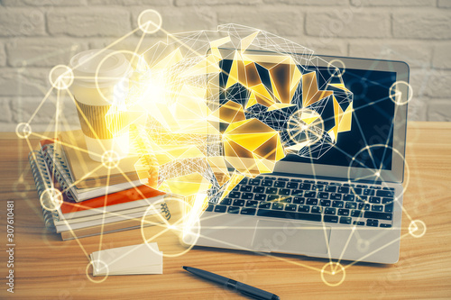 Double exposure of table with computer and brain hologram. Data innovation concept.