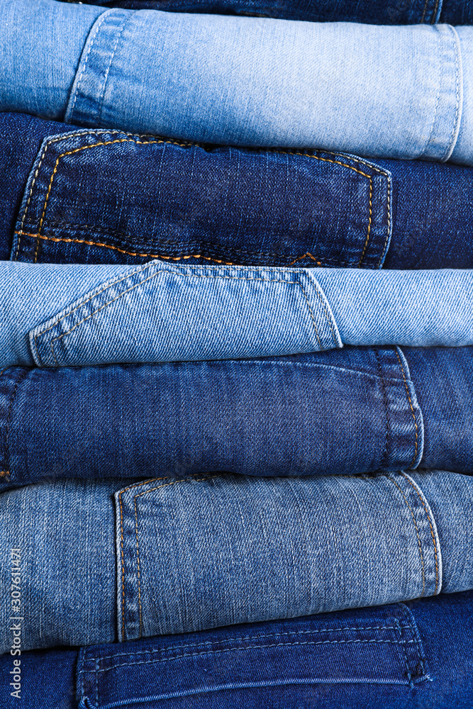 Stack of different jeans as background, closeup Stack of different jeans as background, closeup