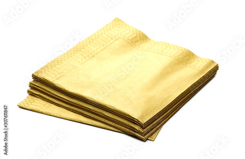 Golden paper napkins, serviette stack isolated on white background