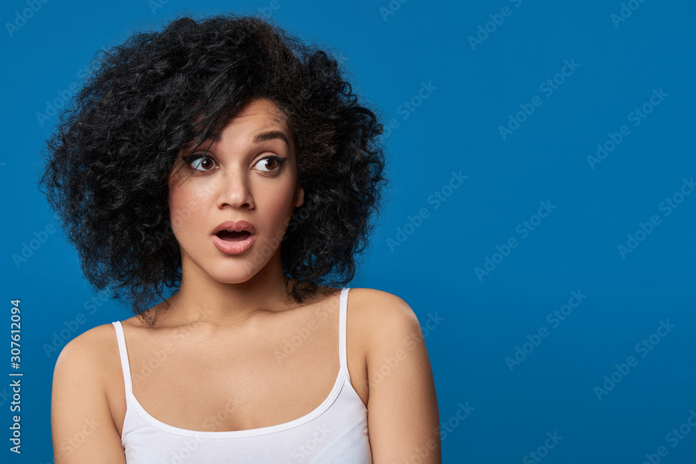 Surprised woman looking to side at blank copy space Surprised woman looking to side at blank copy space