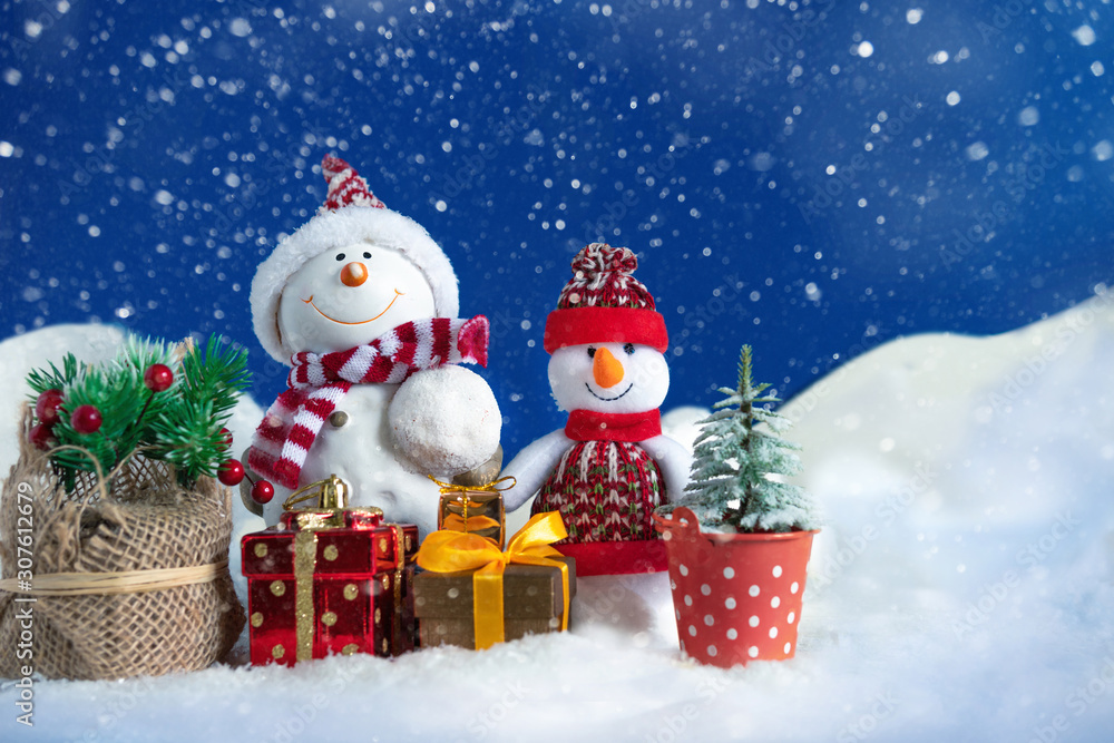 Snowman in a snowdrift with gifts for Christmas and New year Snowman in a snowdrift with gifts for Christmas and New year