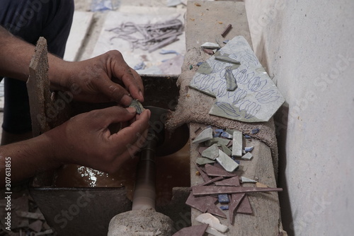 Craftmen cutting marble pieces with a saw