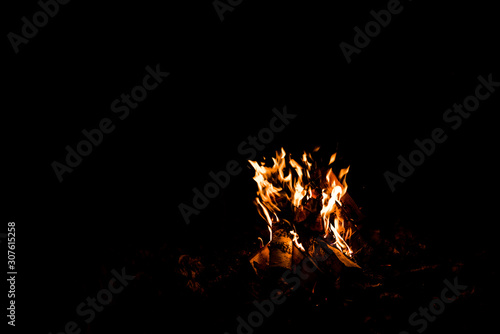 orange flame in bonfire isolated on black © LIGHTFIELD STUDIOS