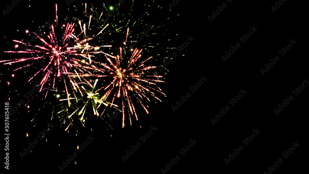 Fototapeta premium Colorful traditional fireworks in night sky, isolated on black