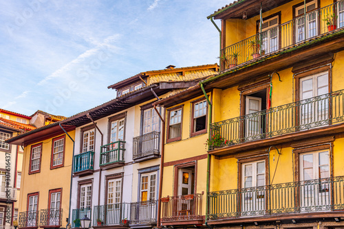 Facades of houses at Largo da Oliveria in the old town of Guimaraes, Portugal photo