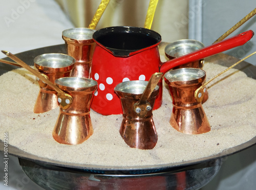 Turkish coffee pots  in sand bath,Cooking Turkish coffee the old-fashioned way photo