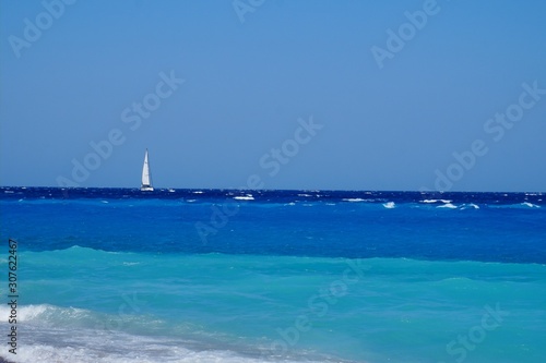 White sailboat in a beautiful sea © Yauheni