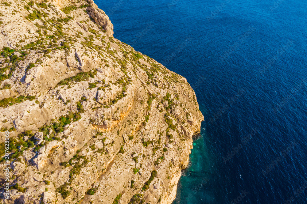 Aerial view of cliffs. Blue clear sky, winter, rocks. Malta country