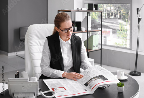 Young businesswoman reading...