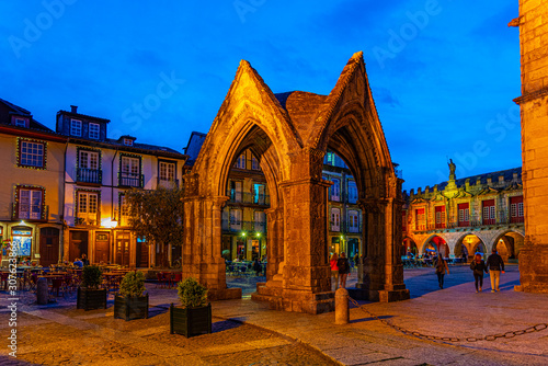 Sunset view of people strolling over Largo da Oliveria in the old town of Guimaraes, Portugal photo