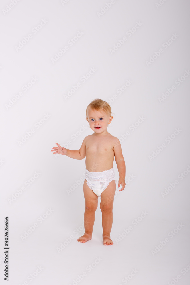 baby girl in a diaper, full-length standing on a white background isolated baby girl in a diaper, full-length standing on a white background isolated