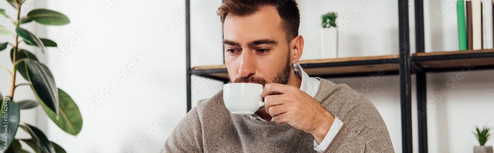 Panoramic shot of blind man drinking coffee at home Panoramic shot of blind man drinking coffee at home