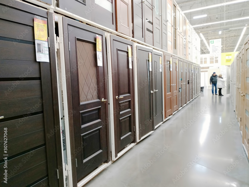 Wooden interior doors are sold in a large building materials supermarket