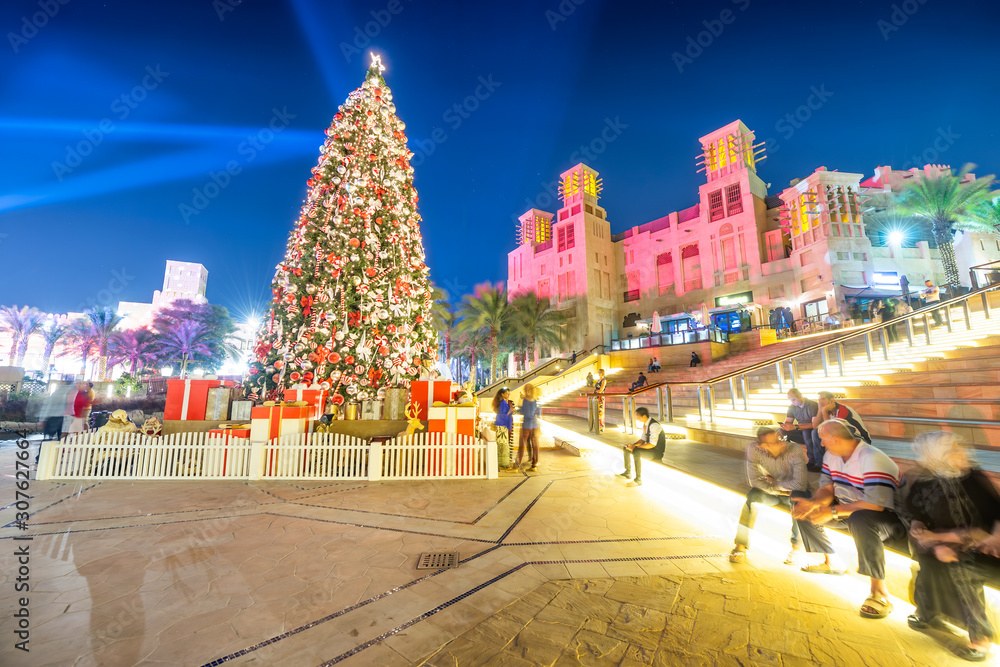 DUBAI, UAE - DECEMBER 9, 2016: Dubai Madinat Jumeirah at night with tourists and Christmas Tree