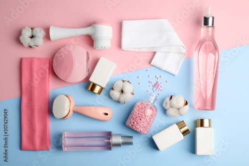 Flat lay composition with face cleansing brushes on color background. Cosmetic tools