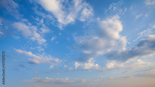 Fototapeta Naklejka Na Ścianę i Meble -  Blue sky clouds background. Beautiful landscape with clouds and orange sun on sky