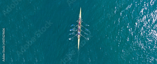 Aerial drone top panoramic view of sport canoe rowing synchronous athletes competing in tropical exotic lake