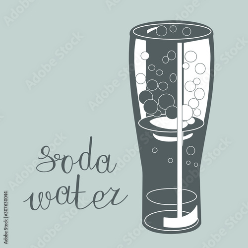 tall glass with carbonated foamy drink on a gray isolated background with the words Soda water