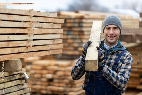 Young male worker in timber warehouse  photo