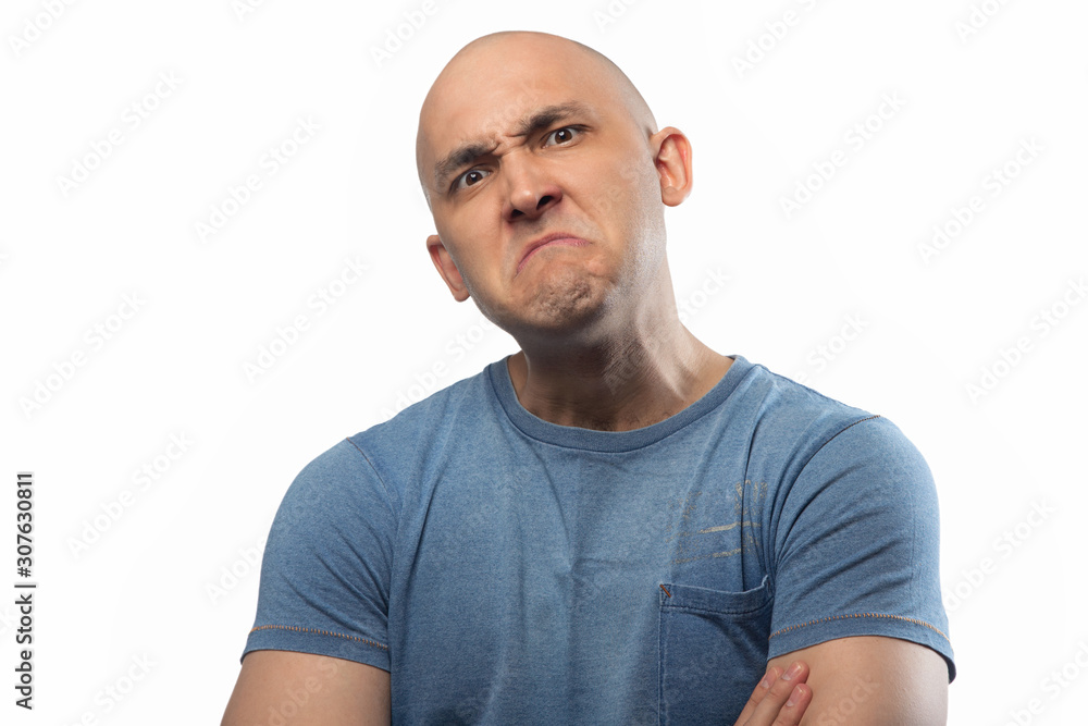 Photo of frowned shaved man on white background
