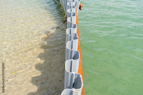 Sheet pile retaining wall on a sea shore. Recycled plastic in use. Water canal made easy. Sheet piling installed into the ground by driving or pushing. Cross-section and low weight. photo