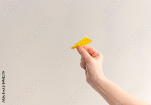 Paper plane in woman hand over white background