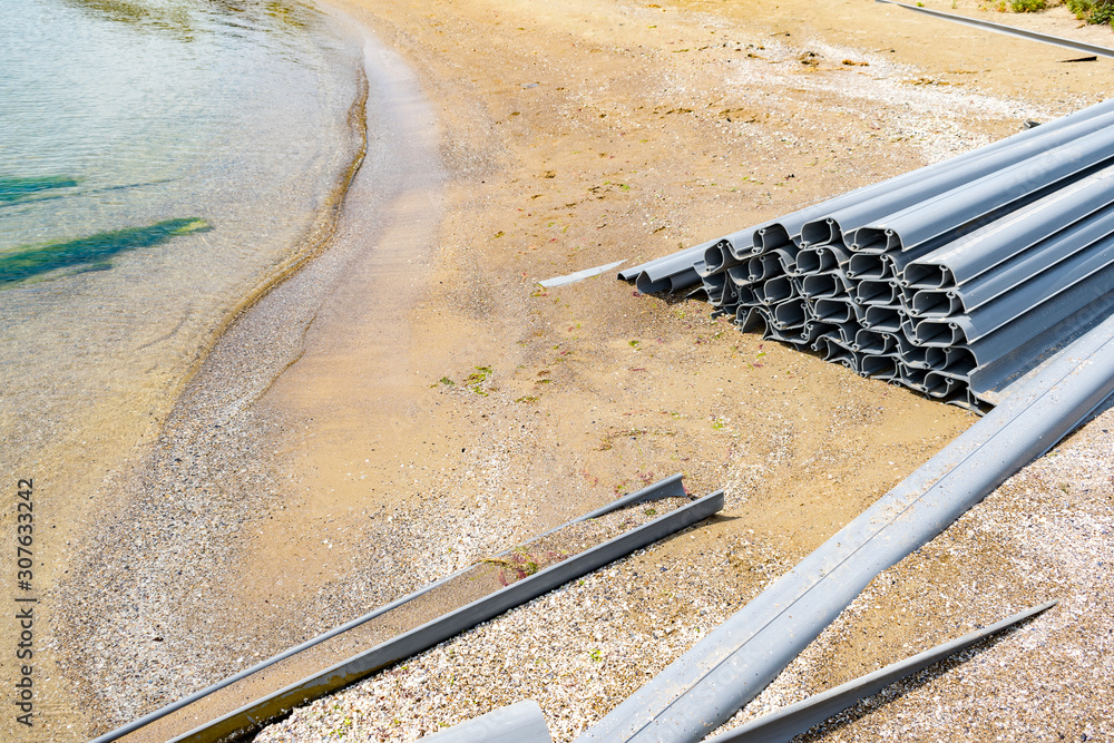Sheet piling on a sea shore. Recycled plastic in use. Sheet piles to be