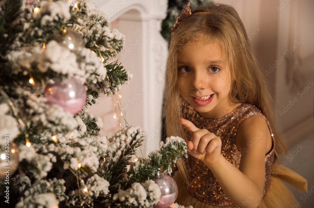 Close up. Portrait of a fun smilling little girl near by Christmas tree. Christmas concept. Close up. Portrait of a fun smilling little girl near by Christmas tree. Christmas concept.