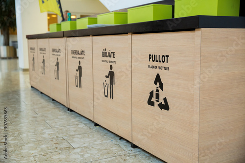 Fotografie Trash bins in public area next to fast food restaurant, separating different kinds of garbage