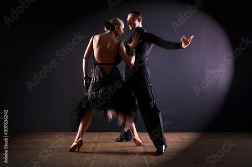 Fototapeta Dancers in ballroom isolated on black background