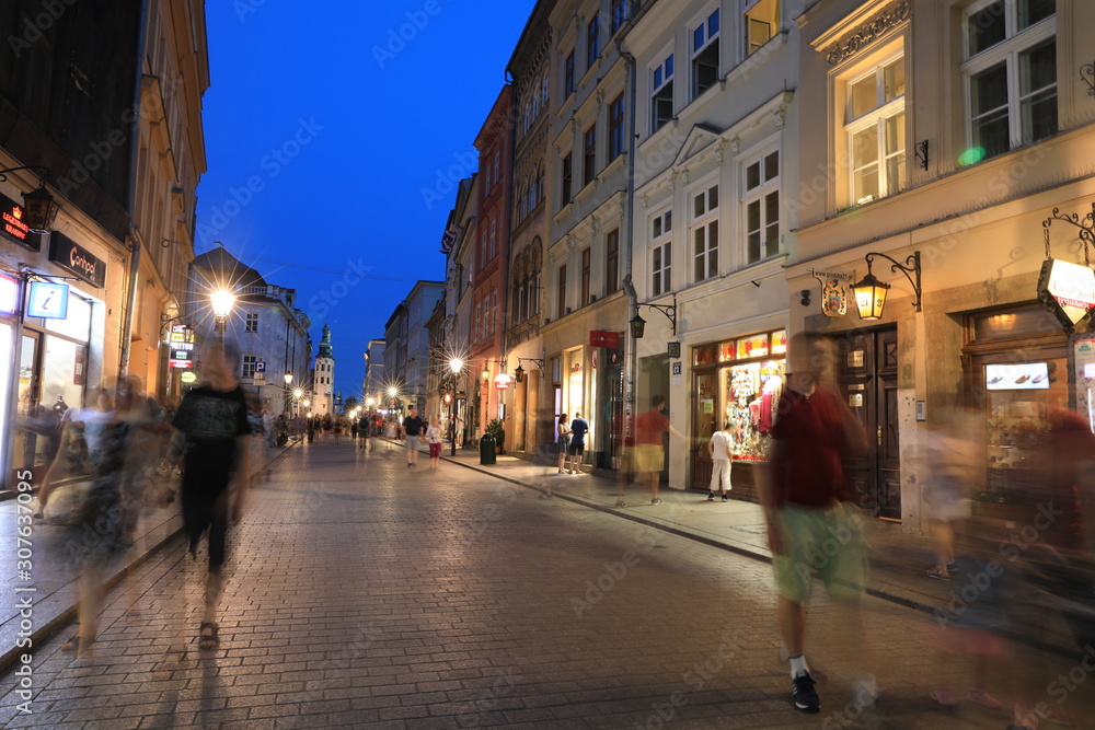 KRAKOW - JUN 15:Classic street nigjt life in Krakow  15 June 2019, Poland. Krakow is one of the most populated metropolitanareas in Europe