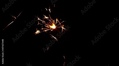 Close up one firework sparkler over black