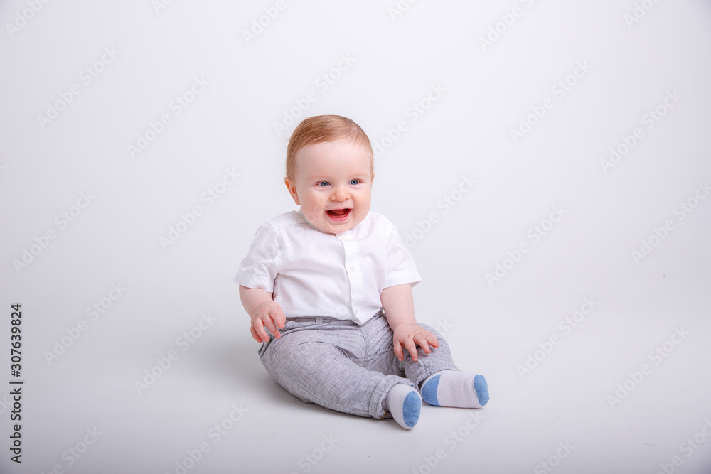 baby boy sitting , smiling isolated on white background baby boy sitting , smiling isolated on white background