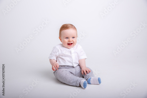 baby boy sitting , smiling isolated on white background