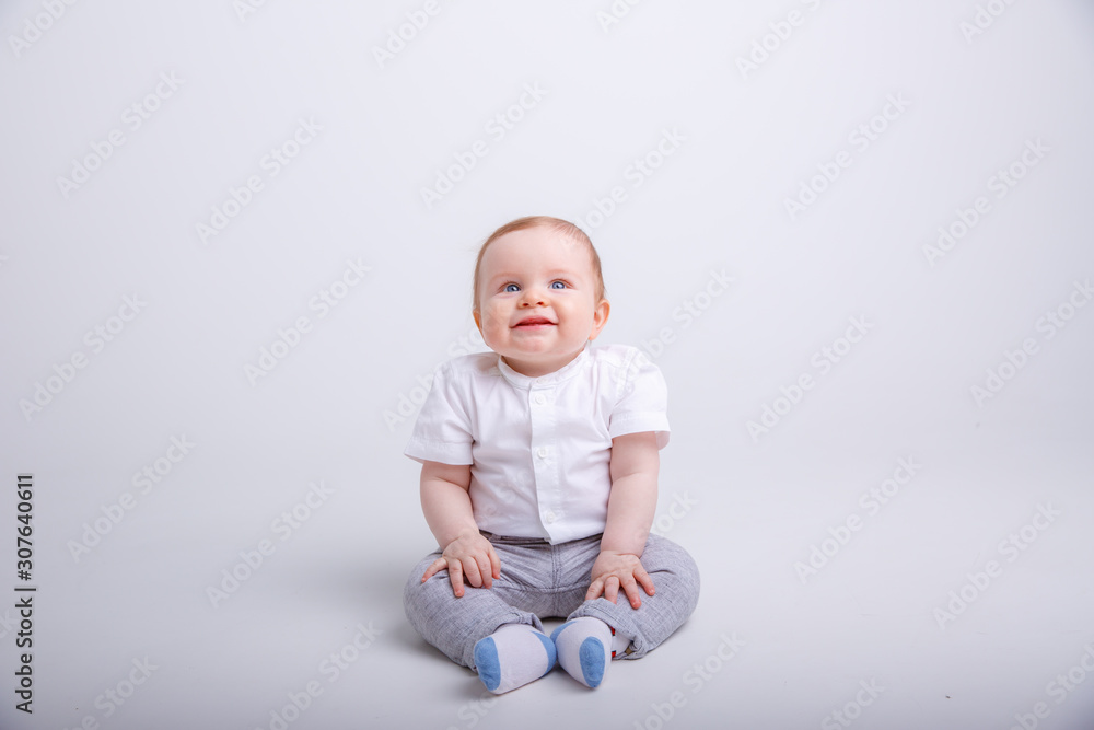 portrait of child smiling isolated on white background. baby boy sitting on a white background portrait of child smiling isolated on white background. baby boy sitting on a white background
