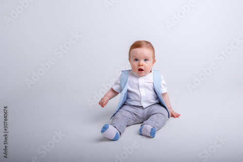 baby boy sitting on a white background