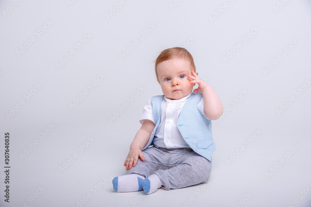 baby boy sitting on a white background baby boy sitting on a white background