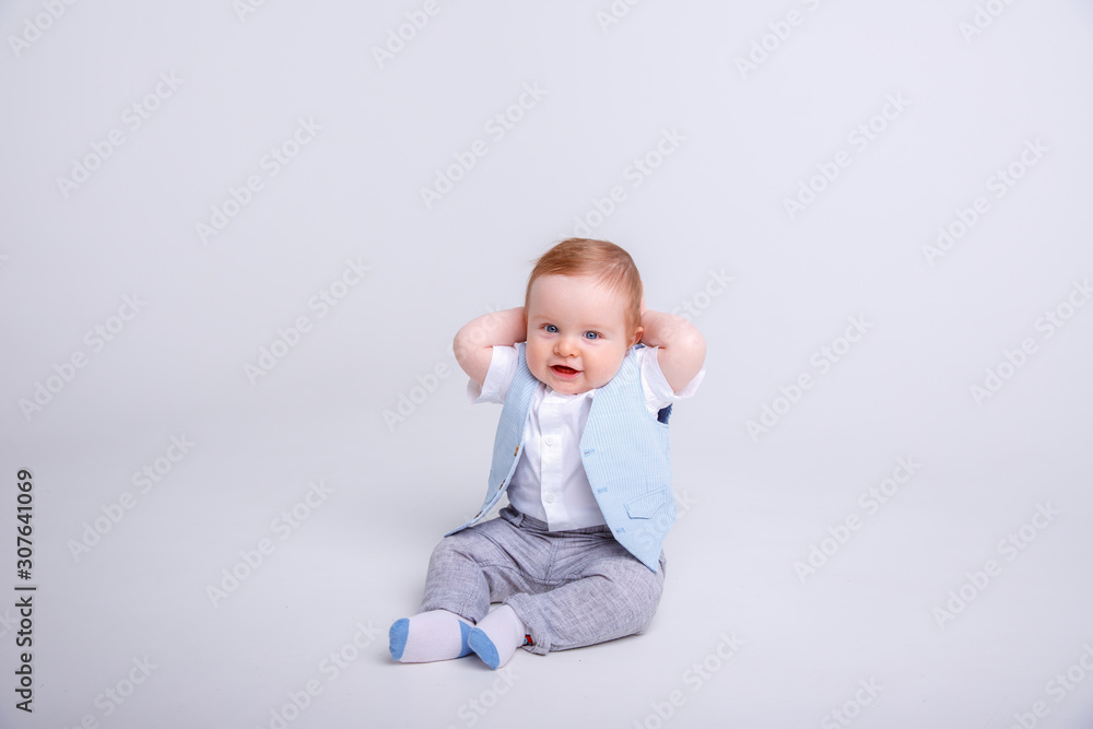 baby boy sitting on a white background