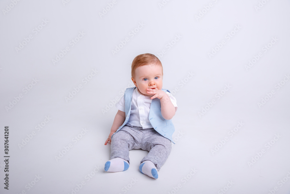 baby boy sitting on a white background baby boy sitting on a white background