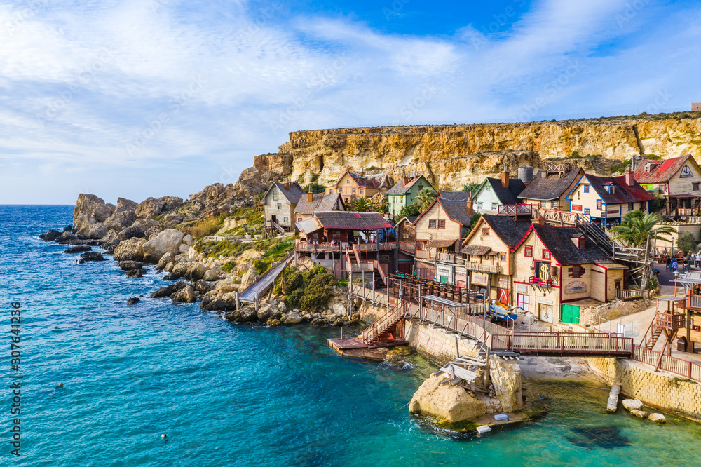 Aerial view of famous tourist attraction Popeye village. Sunny day, blue sea. Mellieha city. Malta island