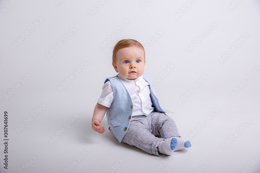 baby boy sitting on a white background baby boy sitting on a white background