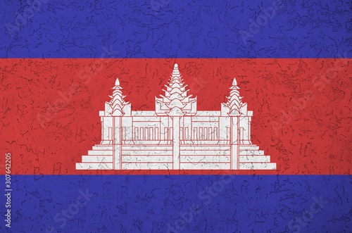 Cambodia flag depicted in bright paint colors on old relief plastering wall. Textured banner on rough background photo