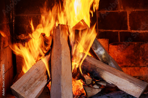 Burning firewood in the fireplace close up.