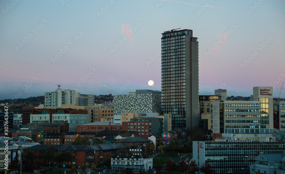 The moon going down over the city of Sheffield at Dawn, South Yorkshire, UK