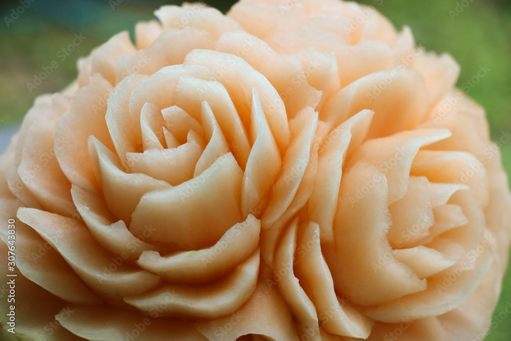 Fruit Carving rose flowers on melon handcraft and beautiful closed up image from Thailand culture background Fruit Carving rose flowers on melon handcraft and beautiful closed up image from Thailand culture background
