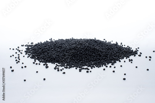 Granules of black termoplastic elastomer on a white background