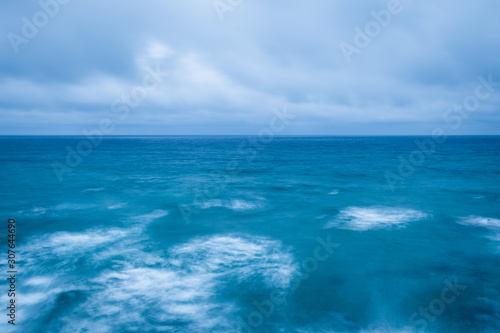 Fototapeta Naklejka Na Ścianę i Meble -  cloudy stormy sky leaving for horizon above a blue surface of the sea