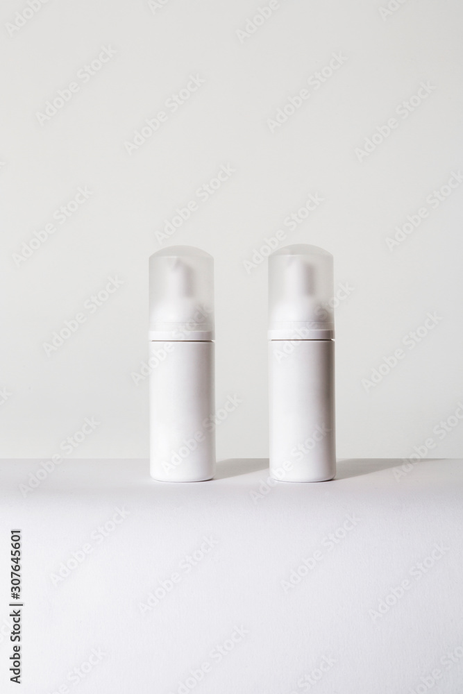 two small white spray bottles for cosmetics two small white spray bottles for cosmetics