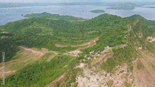 Aerial view of Taal Volcano in an Island withn a lake. Shot of houses on top of the mountain photo