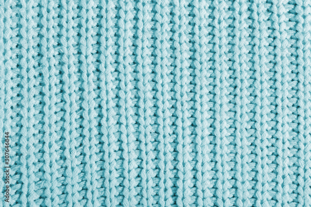 Blue texture of a large knit sweater. Knitted scarf background, winter cozy textile background